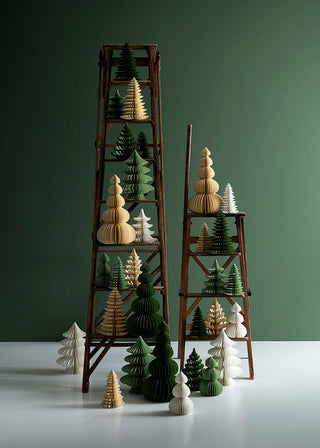 Decorative Christmas trees on wooden ladders against a green background
