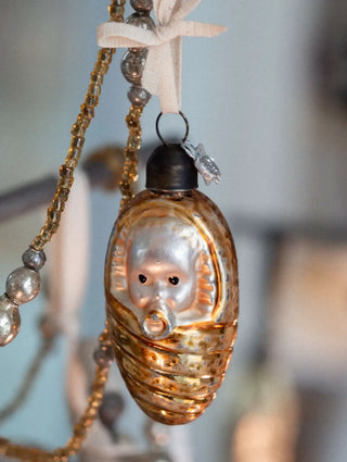 Vintage swaddled baby glass ornament with pacifier