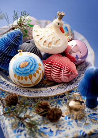 Bungalow Denmark Decorative Christmas ornaments on a patterned surface with a blue background