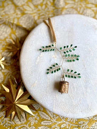 Brass bell with green beads ornament