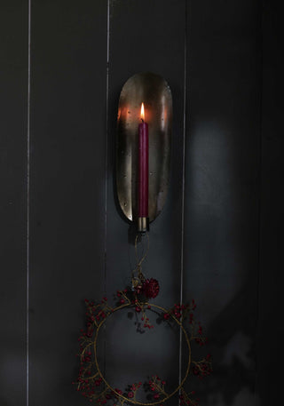 Curved brass candle sconce